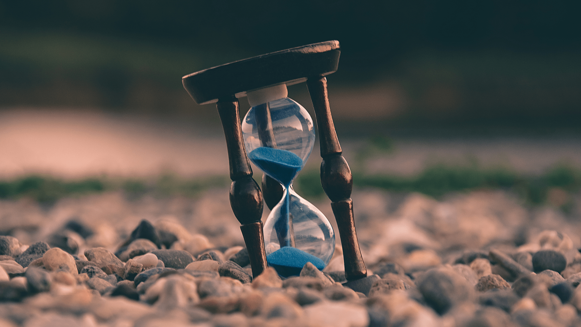 Image of an hourglass in between rocks.
