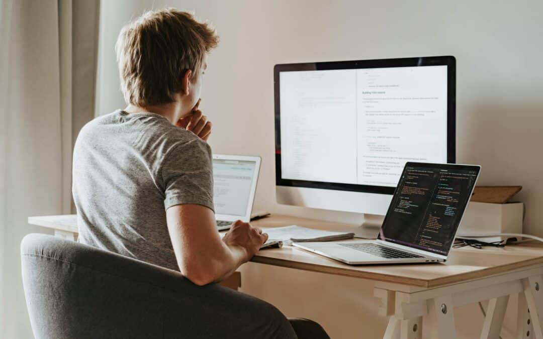 Code developer working on website with multiple screens, SEO optimization and plugin integration.
