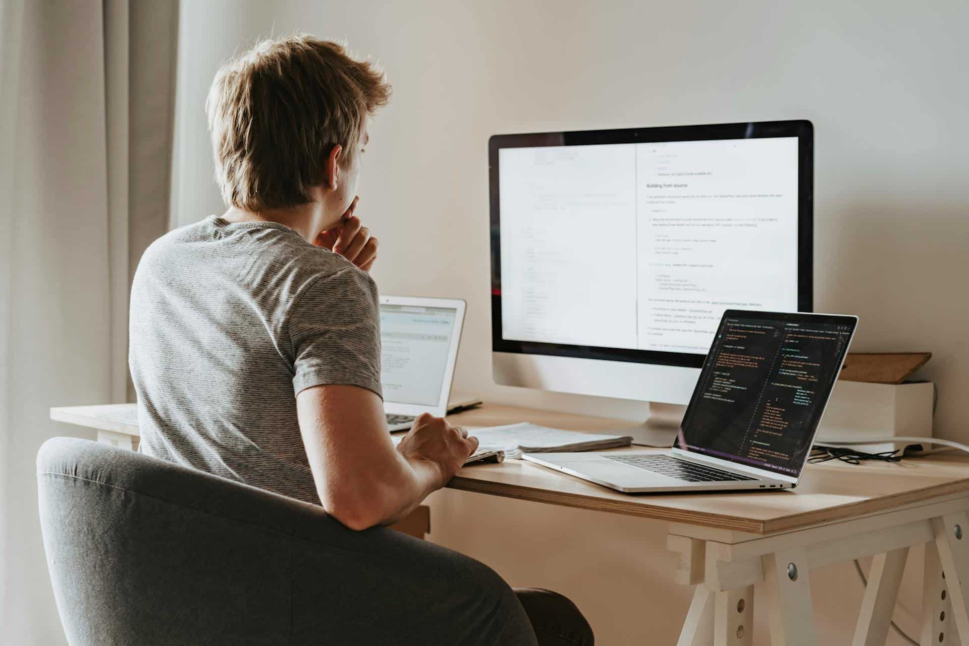 Code developer working on website with multiple screens, SEO optimization and plugin integration.