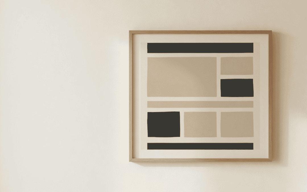 A framed abstract website layout hanging on a plain cream wall.